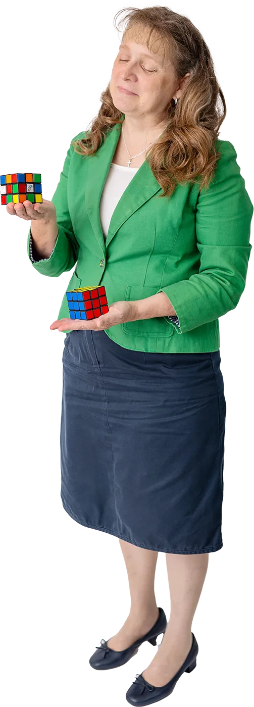 The Master's Math instructor holding two Rubik's cubes
